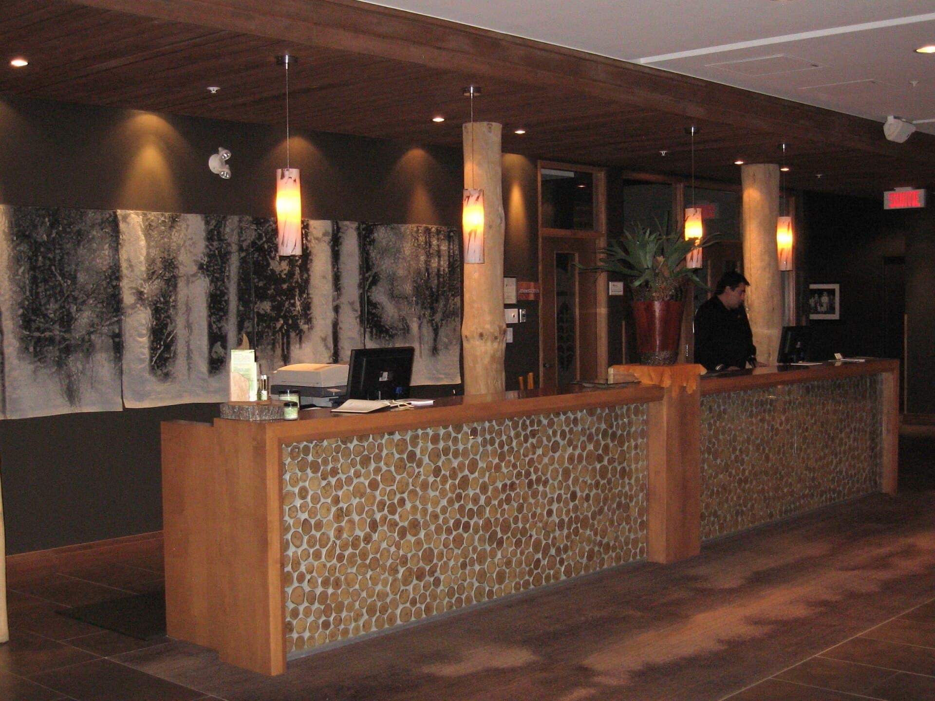 A hotel lobby with timber furniture and a reception desk