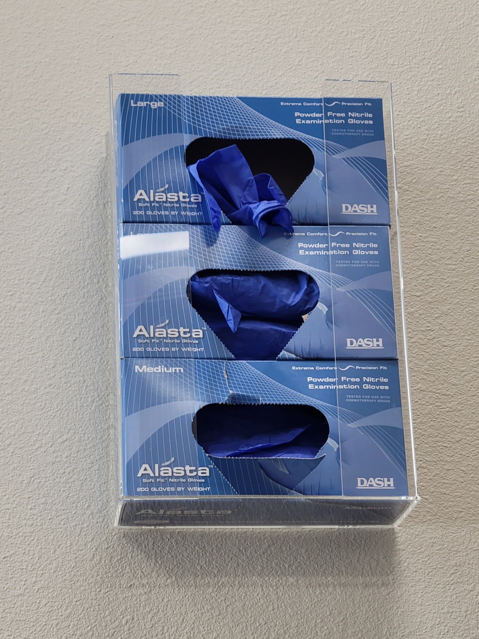 Boxes of nitrile gloves in a wall dispenser